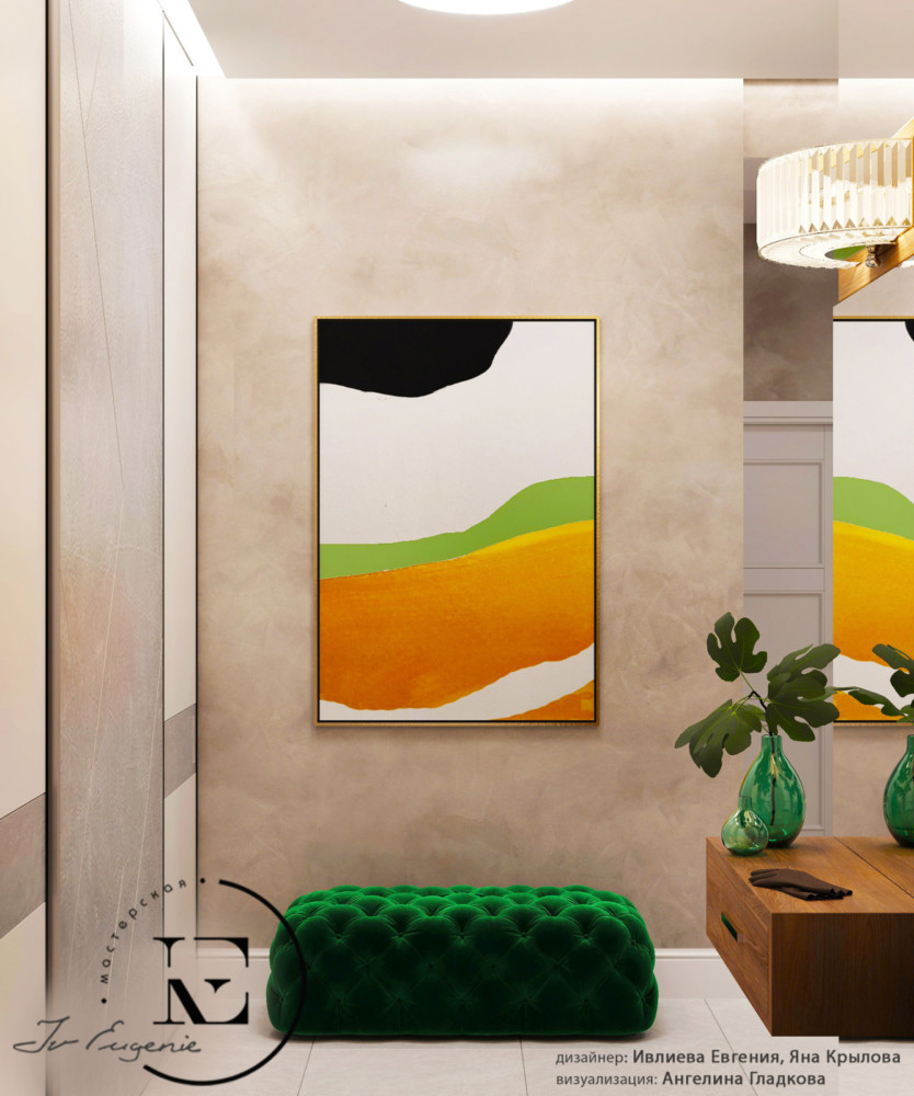 Мы видим входную зону в прихожей в стиле Soleray. Светло-серый цвет пола и стен зрительно расширяют пространство. Мягкий пуф цвета сочной зелени добавляют в интерьер нотки природы. Яркий постер на стене поднимает настроение.